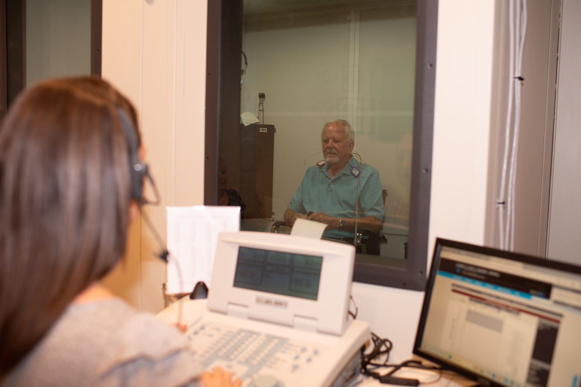 Audiologist educating a patient